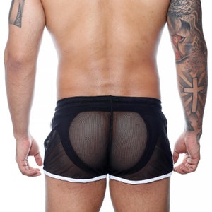 May include: Black mesh shorts with white trim. The shorts feature a mesh panel design and a drawstring waistband. The shorts are designed for athletic wear.