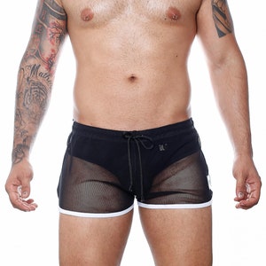 May include: Black mesh shorts with a white trim and drawstring. The shorts have a sporty design and a semi-sheer appearance. The shorts are designed for swimwear or casual wear.