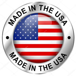 May include: A round, metallic badge with the text "MADE IN THE USA" encircling a central image of the American flag. The flag features red and white stripes and a blue field with white stars.
