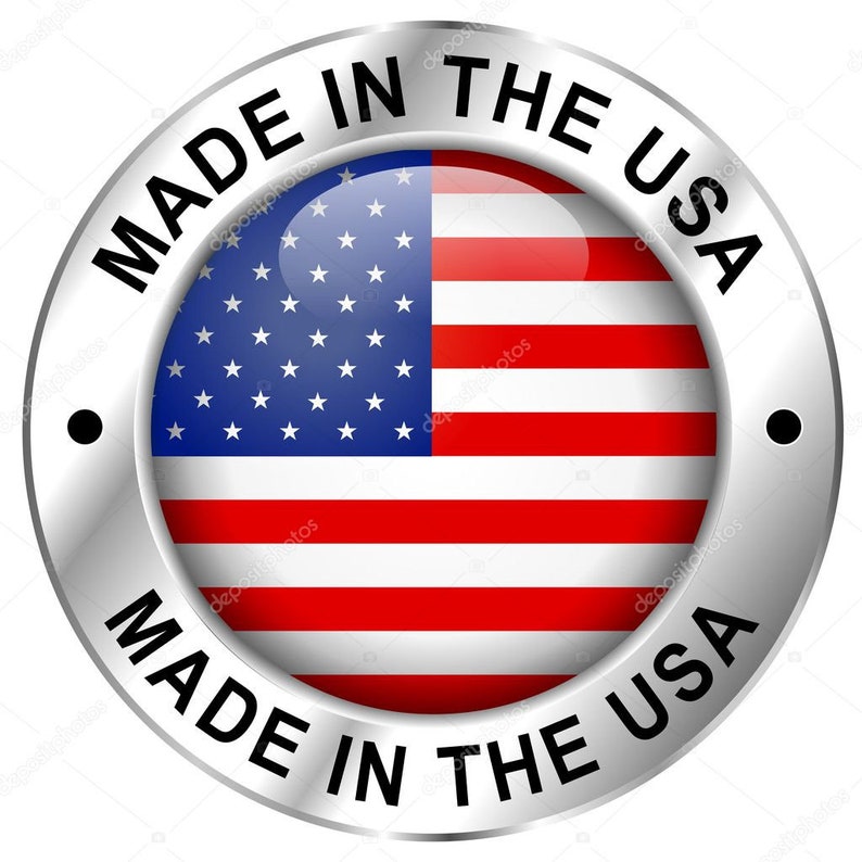 May include: A round, metallic badge with the text "MADE IN THE USA" encircling a central image of the American flag. The flag features red and white stripes and a blue field with white stars.