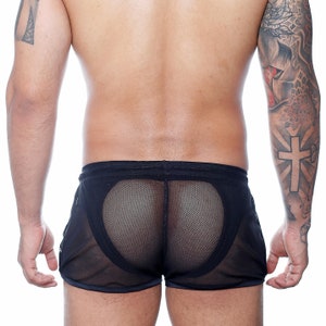May include: Black mesh shorts with a semi-sheer design. The shorts feature a drawstring waistband and a contrasting trim along the edges. The back of the shorts has a unique mesh panel.