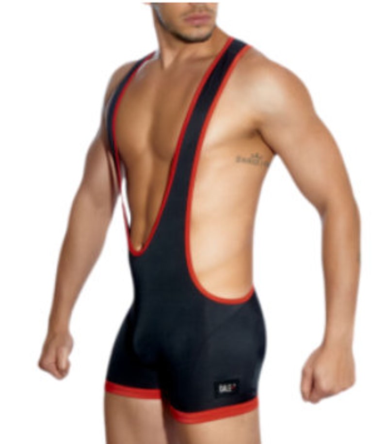May include: Black wrestling singlet with red trim. The singlet features a scoop neck and a racerback design. The garment has a small logo on the lower left leg. The singlet is made of a stretchy material.