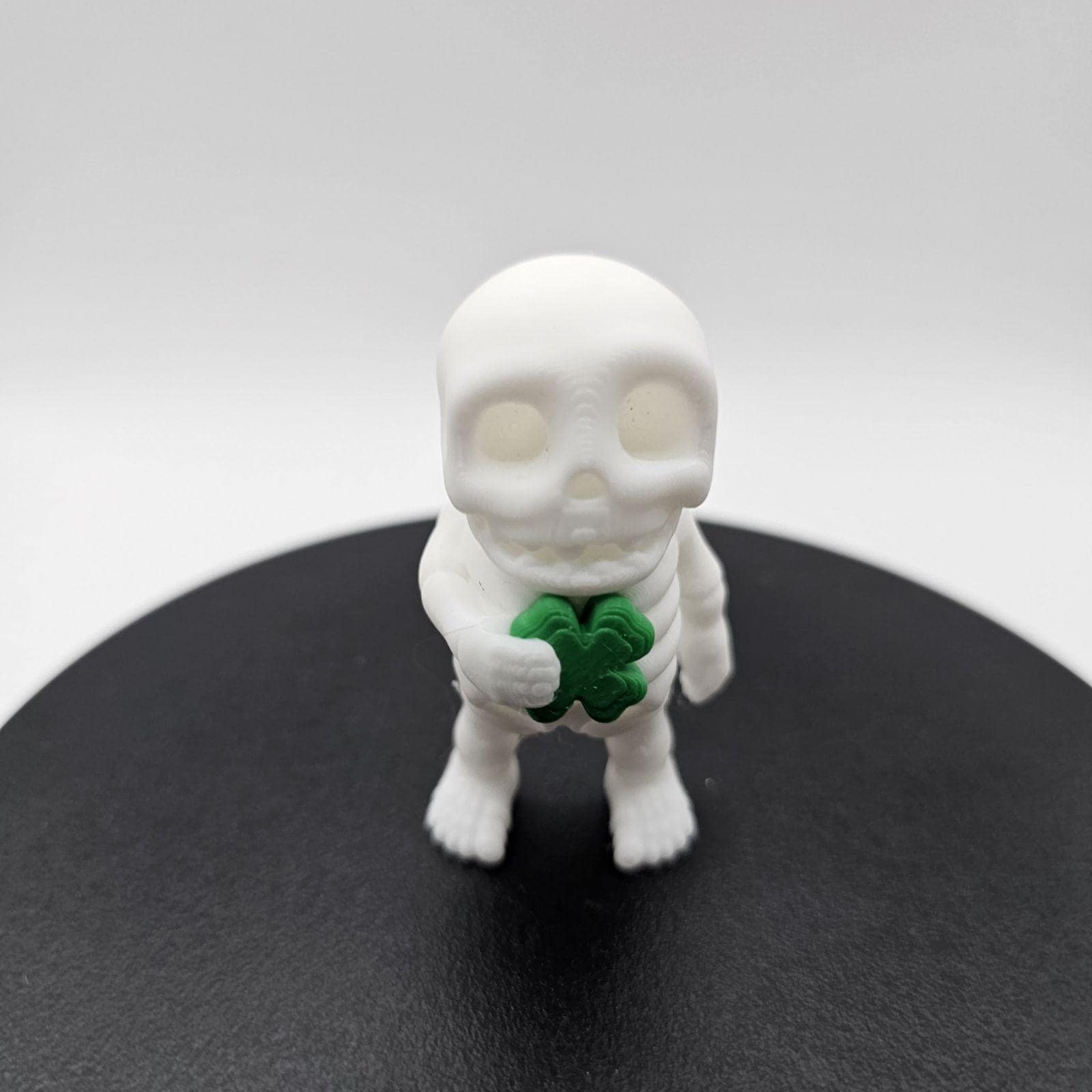 Skeleton Fidget Buddy - St. Patrick’s Day Edition with Shamrock - 3D Printed Articulated Sensory Toy by Zou 3D