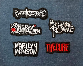 May include: Five embroidered patches featuring band names: Evanescence, Bullet for My Valentine, My Chemical Romance, Marilyn Manson, and The Cure. Each patch has a black background with white or red lettering.