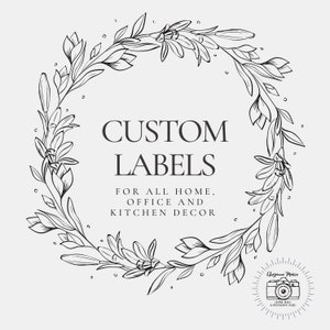 May include: A monochrome floral wreath encircles the words "CUSTOM LABELS" and the text "FOR ALL HOME, OFFICE AND KITCHEN DECOR". A small logo with a camera and the words "Cheyenne Marie" is in the lower right corner.