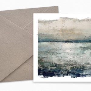 May include: An abstract art print with a landscape theme. The artwork features a textured, layered design in shades of blue, gray, and beige. A neutral-toned envelope is visible in the background, suggesting a greeting card or stationery set.