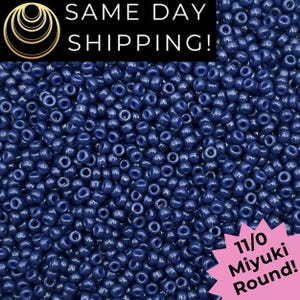 May include: A close-up shot of a large pile of dark blue Miyuki round beads. The beads are small and uniform in size, with a glossy finish. Text at the top reads "SAME DAY SHIPPING!" and a pink starburst graphic reads "11/0 Miyuki Round!"