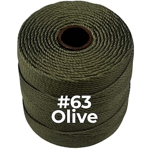 May include: A cylindrical spool of olive green twisted cord featuring a dark brown center core. The side of the spool is printed with the white text #63 Olive, indicating the specific color and product identification for this craft supply.