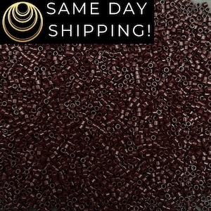 May include: A close-up shot of a pile of small, cylindrical, dark brown beads. The beads are densely packed together, filling the frame. The text "SAME DAY SHIPPING!" is displayed in white on a black background in the upper left corner.