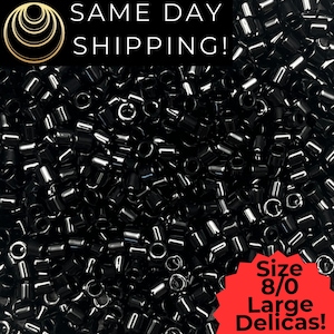 May include: Close-up of a pile of small, black, cylindrical beads. The beads are glossy and reflect light. Text in the image reads "SAME DAY SHIPPING!" and "Size 8/0 Large Delicas!"