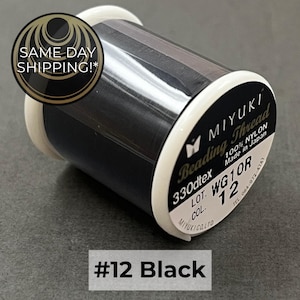 May include: A spool of black Miyuki beading thread made of 100% nylon. The label on the white plastic spool end displays the text Miyuki Beading Thread, 330dtex, 100% Nylon, Made in Japan, Lot WG10R, and Col 12. The text #12 Black is visible.