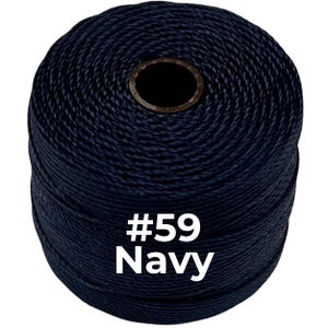 May include: A cylindrical spool of dark navy blue cord wound tightly in a continuous spiral pattern. The text #59 Navy is printed in white on the front of the spool, which features a dark brown circular core at the center top.
