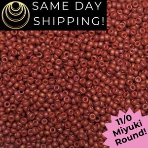 May include: Close-up of a pile of small, round, reddish-brown beads. The beads are labeled as 11/0 Miyuki Round. The image also includes the text "SAME DAY SHIPPING!"