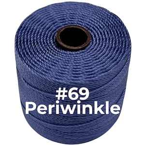May include: A cylindrical spool of periwinkle blue bonded nylon thread. The thread is tightly wound around a dark brown core. The text #69 Periwinkle is printed in white across the center of the spool, indicating the color and size.