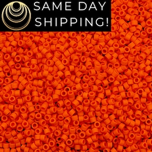 May include: Close-up of a pile of bright orange, cylindrical beads. The beads are evenly distributed, filling the frame. The image includes the text "SAME DAY SHIPPING!" in white letters on a black background.