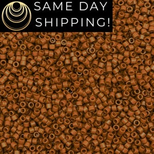 May include: Close-up of a pile of small, cylindrical, brown beads. The beads are uniform in size and shape, with a hole running through the center. The text "SAME DAY SHIPPING!" is displayed in white letters on a black background.