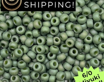 May include: A close-up shot of a pile of olive green 6/0 Miyuki round beads. The beads are small, cylindrical, and have a hole running through the center. The image also contains the text "SAME DAY SHIPPING!"