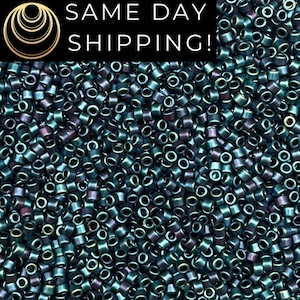 May include: A large collection of small, cylindrical seed beads with a metallic, iridescent finish in shades of dark teal, green, and purple. The text SAME DAY SHIPPING! is printed in white on a black rectangular banner at the top.