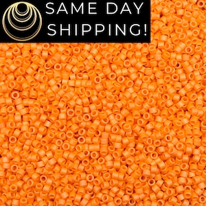 May include: A close-up image of a large quantity of small, round, orange plastic beads. The beads are all the same size and shape, and they are arranged in a random pattern.