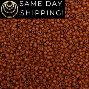 May include: Close-up of a pile of small, cylindrical, copper-colored beads. The beads are densely packed, creating a textured surface. The image includes the text "SAME DAY SHIPPING!" in white letters on a black background.