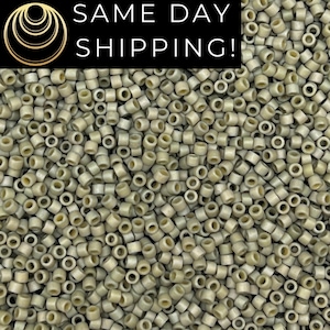 May include: A close-up shot of numerous small, cylindrical hair extension beads in a neutral, light beige color. The beads are densely packed together, filling the frame. The text "SAME DAY SHIPPING!" is displayed in white on a black background.