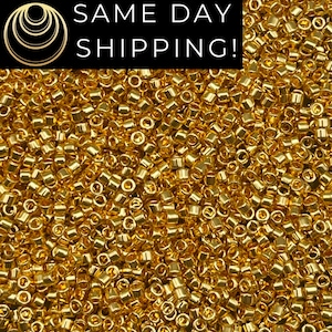 May include: Close-up of a pile of small, shiny, gold-colored beads. The beads are cylindrical with rounded edges and a hole running through the center. The text "SAME DAY SHIPPING!" is in a black box at the top.