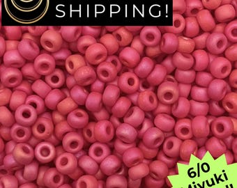 May include: Close-up of a pile of 6/0 Miyuki round beads in shades of pink and coral. The beads are cylindrical with a hole through the center. The image includes text that says "SAME DAY SHIPPING!" and "6/0 Miyuki Round!"