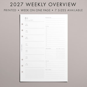 May include: A white paper planner insert for 2027 with a weekly overview layout. The page features sections for priorities, to-do lists, trackers, goals, and next week. It includes six punch holes on the left side and text reading 2027 WEEKLY OVERVIEW.