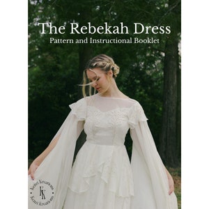 May include: A white dress with a ruffled neckline and long sleeves. The dress has a flowing skirt and a cape-like overlay. The dress is decorated with small, white dots. The text "The Rebekah Dress" and "Pattern and Instructional Booklet" is visible at the top of the image.