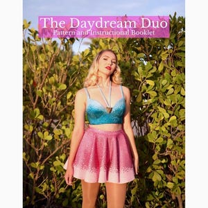 May include: A woman wearing a blue and white ombre crop top with a pink and white ombre skirt. The top and skirt are both embellished with rhinestones. The text "The Daydream Duo Pattern and Instructional Booklet" is displayed at the top of the image.