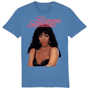 May include: A blue t-shirt with a picture of Donna Summer and the text "Donna Summer" in pink neon lettering.