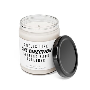 May include: A white candle jar with a black label that reads "Smells Like One Direction Getting Back Together" and "All Natural Aromatherapy Candle". The lid is black and is off the jar.