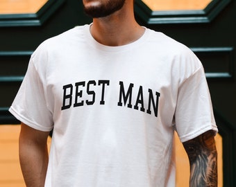 May include: White t-shirt with the text "BEST MAN" printed in black.