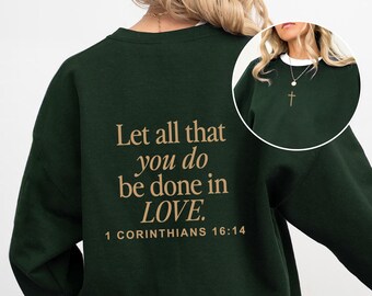 May include: A dark green sweatshirt with the text "Let all that you do be done in LOVE. 1 Corinthians 16:14" printed on the back in a light brown color.