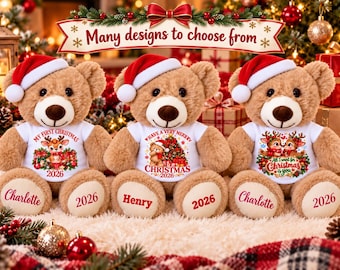 May include: Three light brown plush teddy bears wearing red and white Santa hats and white t-shirts with Christmas graphics and the year 2026. The bears have names Charlotte, Henry, and Charlotte printed on their left feet and 2026 on their right feet.