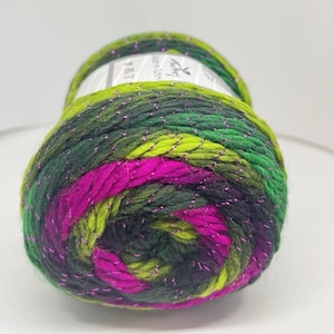 May include: A skein of yarn featuring a variegated color palette of dark green, lime green, and vibrant magenta. The yarn is constructed with a twisted ply texture and is interwoven with a thin, metallic silver thread that adds a subtle shimmer.