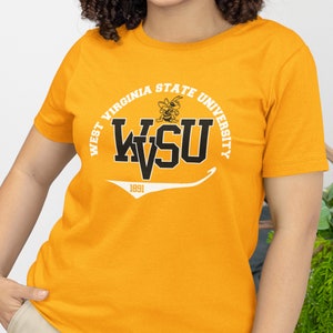 May include: A yellow t-shirt with a white and black graphic of the West Virginia State University logo. The logo includes the text "West Virginia State University", "WVSU", and "1891".