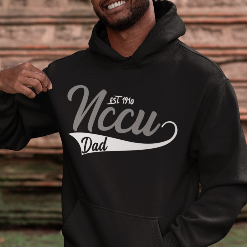 May include: Black hooded sweatshirt with a white graphic design that says "NCCU EST. 1910" with a white baseball-style arc underneath that says "Dad".