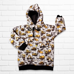 May include: A white hooded sweatshirt with a black zipper and a black drawstring. The sweatshirt has a pattern of yellow construction vehicles on a gray background.