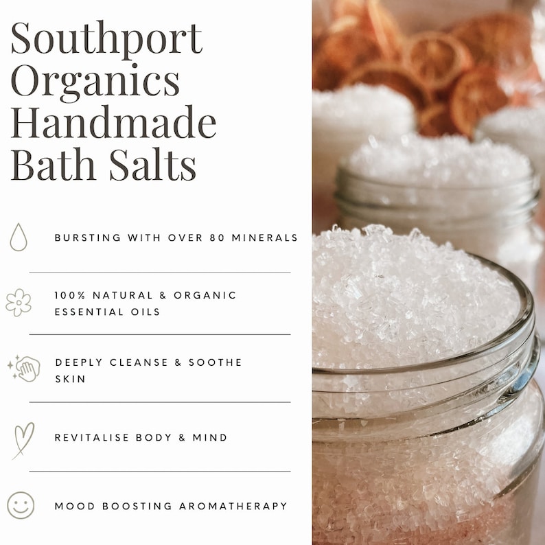 May include: Close-up of glass jars filled with white bath salts. The jars are in focus, with a blurred background of more jars and dried orange slices. Text on the left reads "Southport Organics Handmade Bath Salts". Additional text highlights the product's benefits.