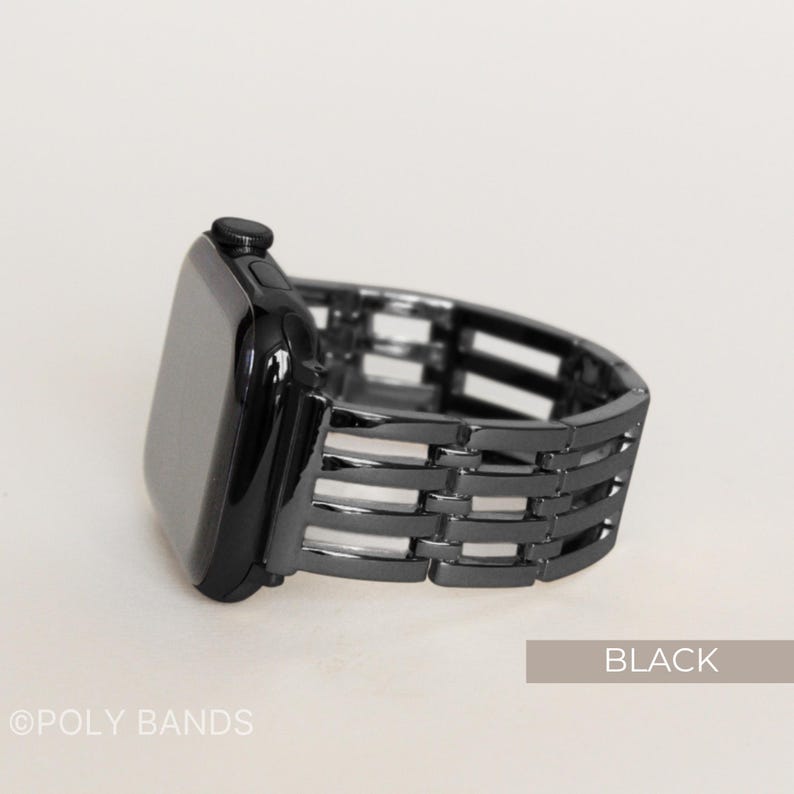 May include: Black watch band with a woven design. The watch face is black and rectangular. The band is made of metal and has a series of horizontal and vertical bars. The word "BLACK" is printed on a light brown rectangle.