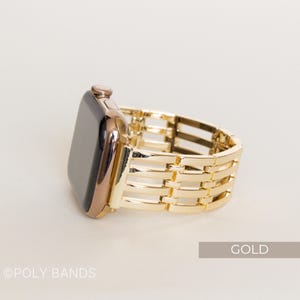 May include: A gold-colored Apple Watch with a matching gold band. The band has a woven design. The word "GOLD" is in a rectangular box in the lower right corner. The text "@POLY BANDS" is in the lower left corner.