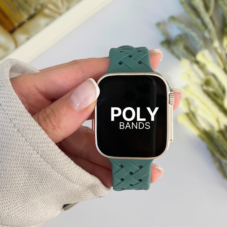 May include: A green braided silicone watch band with the text "POLY BANDS" on the watch face.