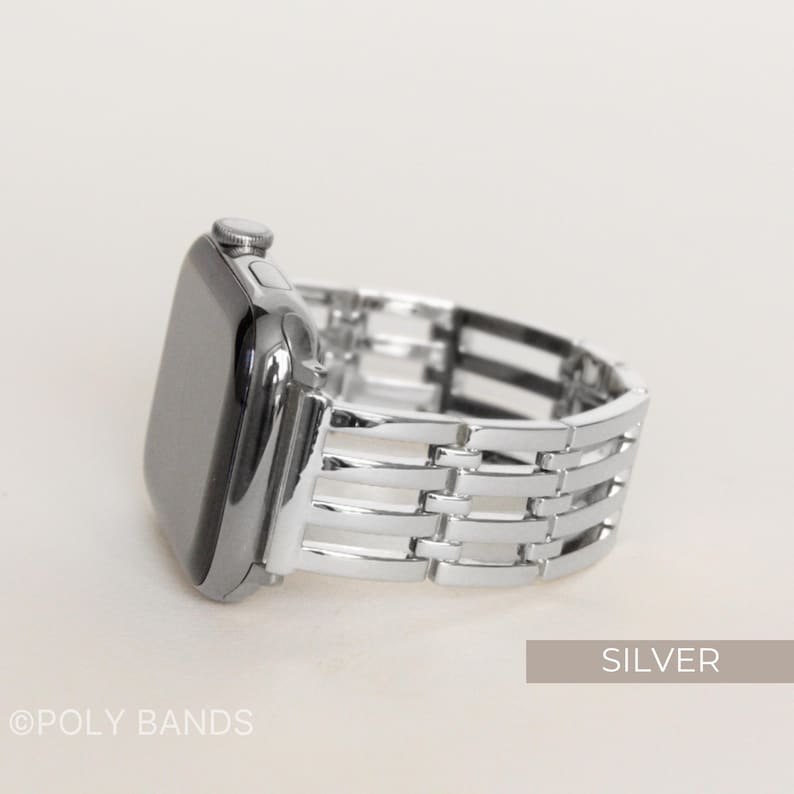 May include: Silver-colored watch band with a woven design. The watch face is black and shiny. The band is made of metal and has a polished finish. The word "SILVER" is in a rectangular box in the bottom right corner.