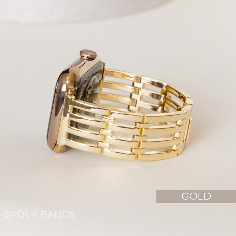May include: A gold-colored Apple Watch with a matching gold band. The band features a woven design with horizontal and vertical bars. The word "GOLD" is in a rectangular box in the lower right corner. The text "&copy;POLY BANDS" is in the lower left corner.