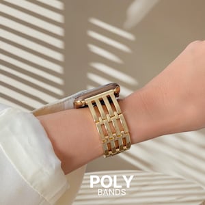 May include: A gold-colored watch band with a rectangular link design is shown on a wrist. The watch face is also gold. The text "POLY BANDS" is at the bottom of the image.