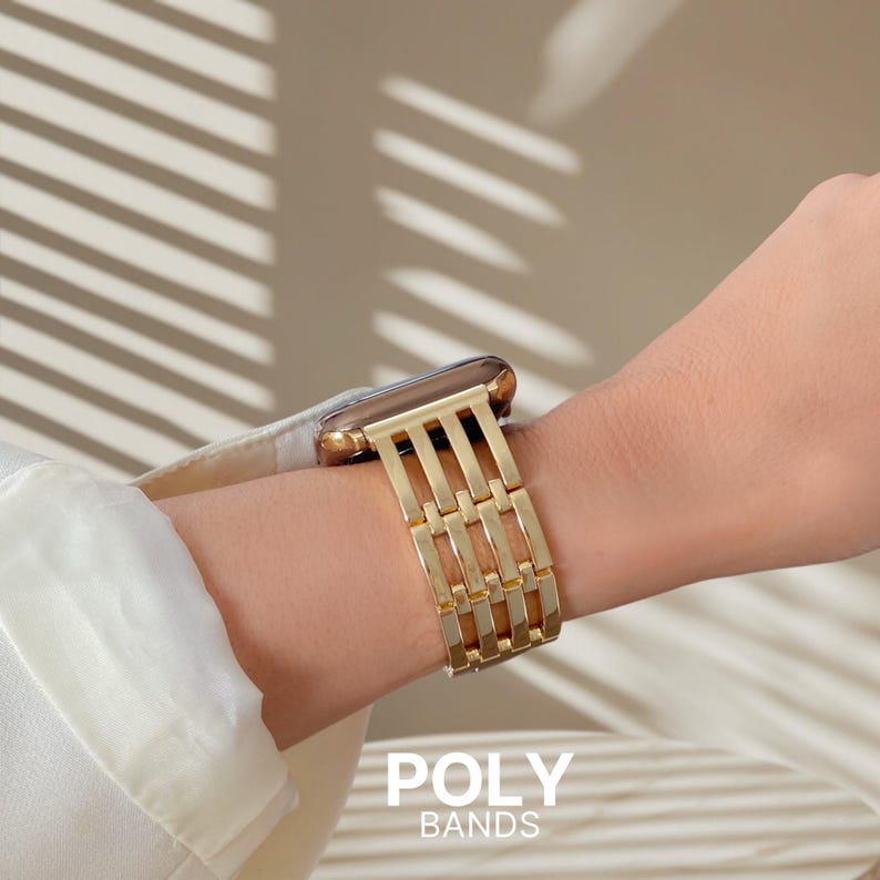 May include: A gold-colored watch band with a rectangular link design is shown on a wrist. The watch face is also gold. The text "POLY BANDS" is at the bottom of the image.