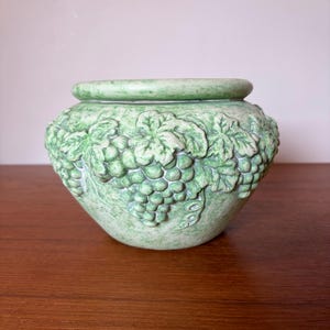 May include: A set of three ceramic mugs with a speckled, matte finish. The mugs are in shades of cream, light grey, and dark grey. Each mug has a simple, minimalist design, ideal for coffee or tea.