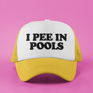 May include: A yellow and white trucker hat with the text "I PEE IN POOLS" in black.