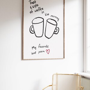 May include: A framed print with the handwritten text "Two cups of coffee in the morning" above two coffee cup illustrations. Below, the text "My favorite love poem" is written with a red heart.